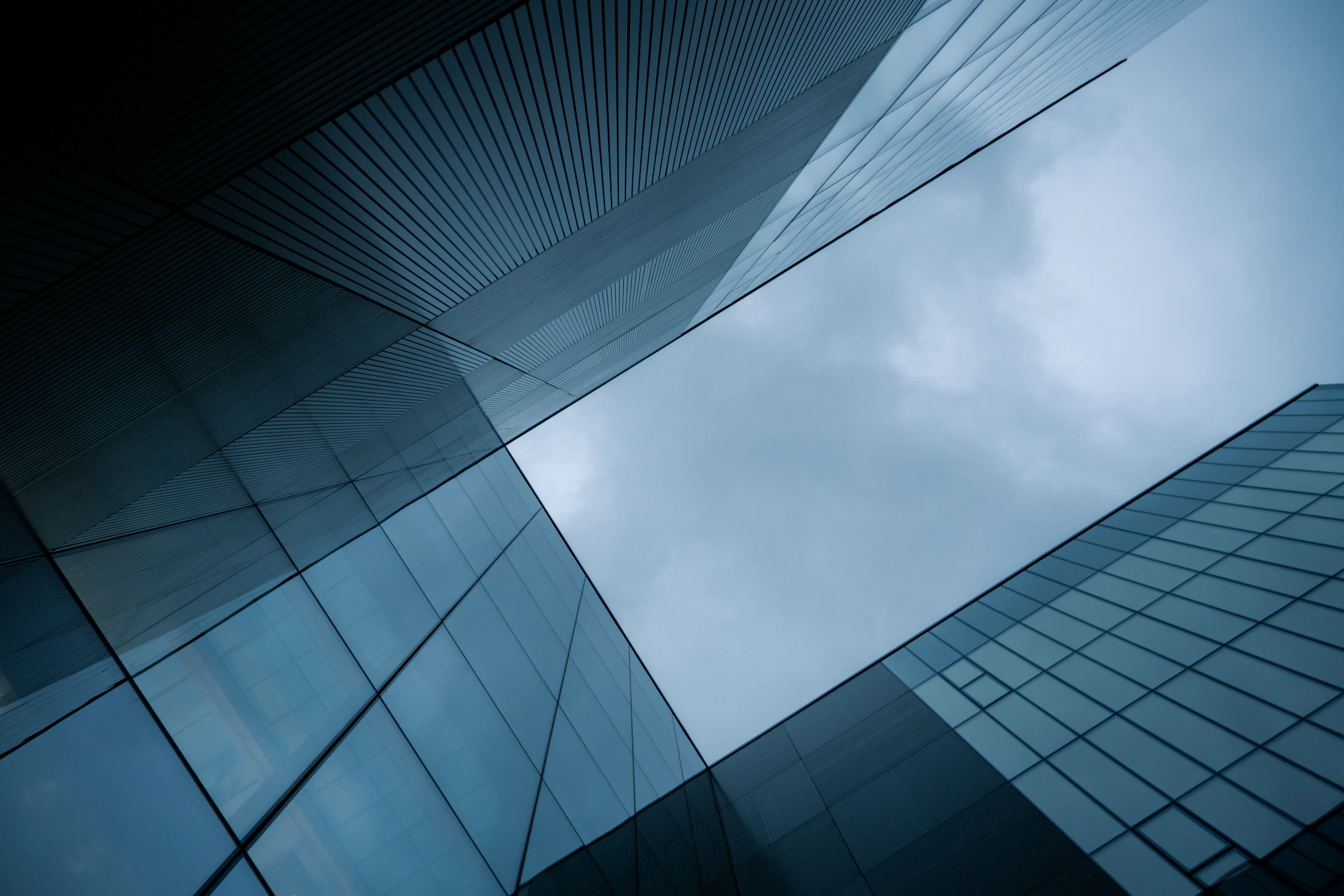 Geometric glass architecture with one clear opening to the sky